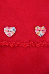 close up kids red poncho with heart buttons