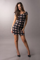 Woman with pink and black plaid dress in a photostudio