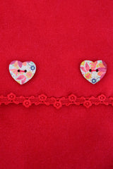 close up kids red poncho with heart buttons