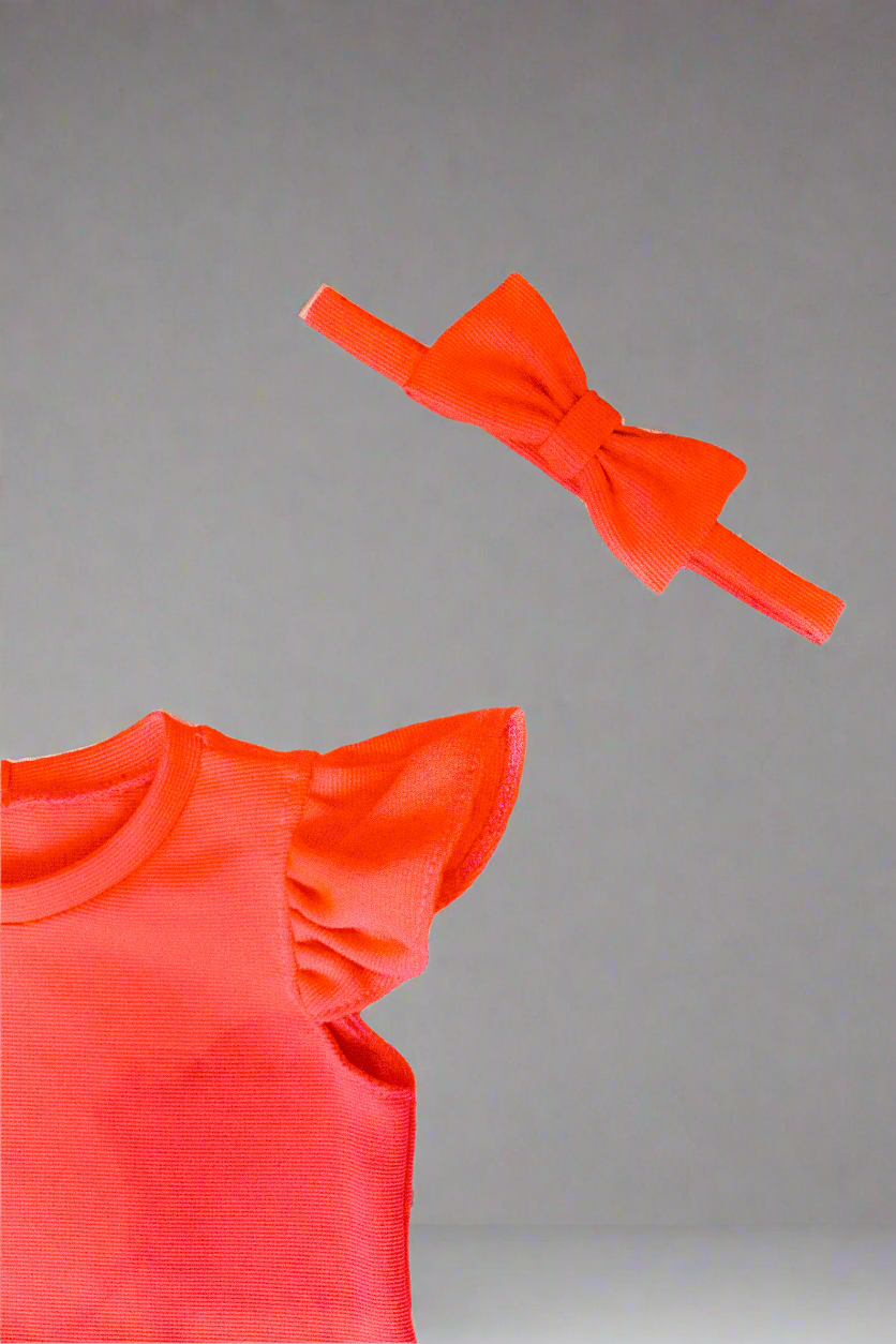 close up girls top with puff sleeves and round neck and a bow headband