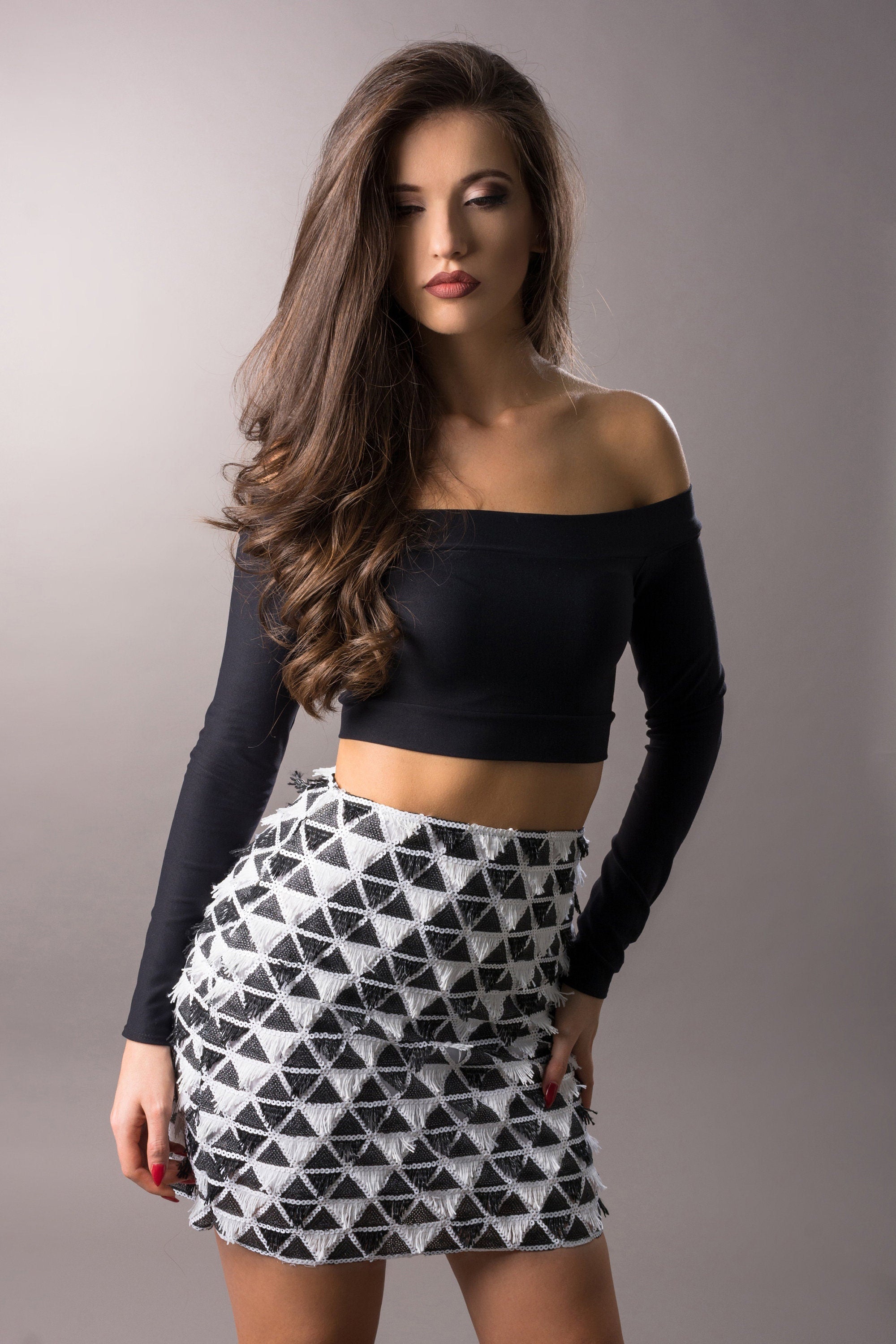 woman wearing black and white textured mini skirt