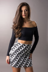 woman wearing black and white textured mini skirt