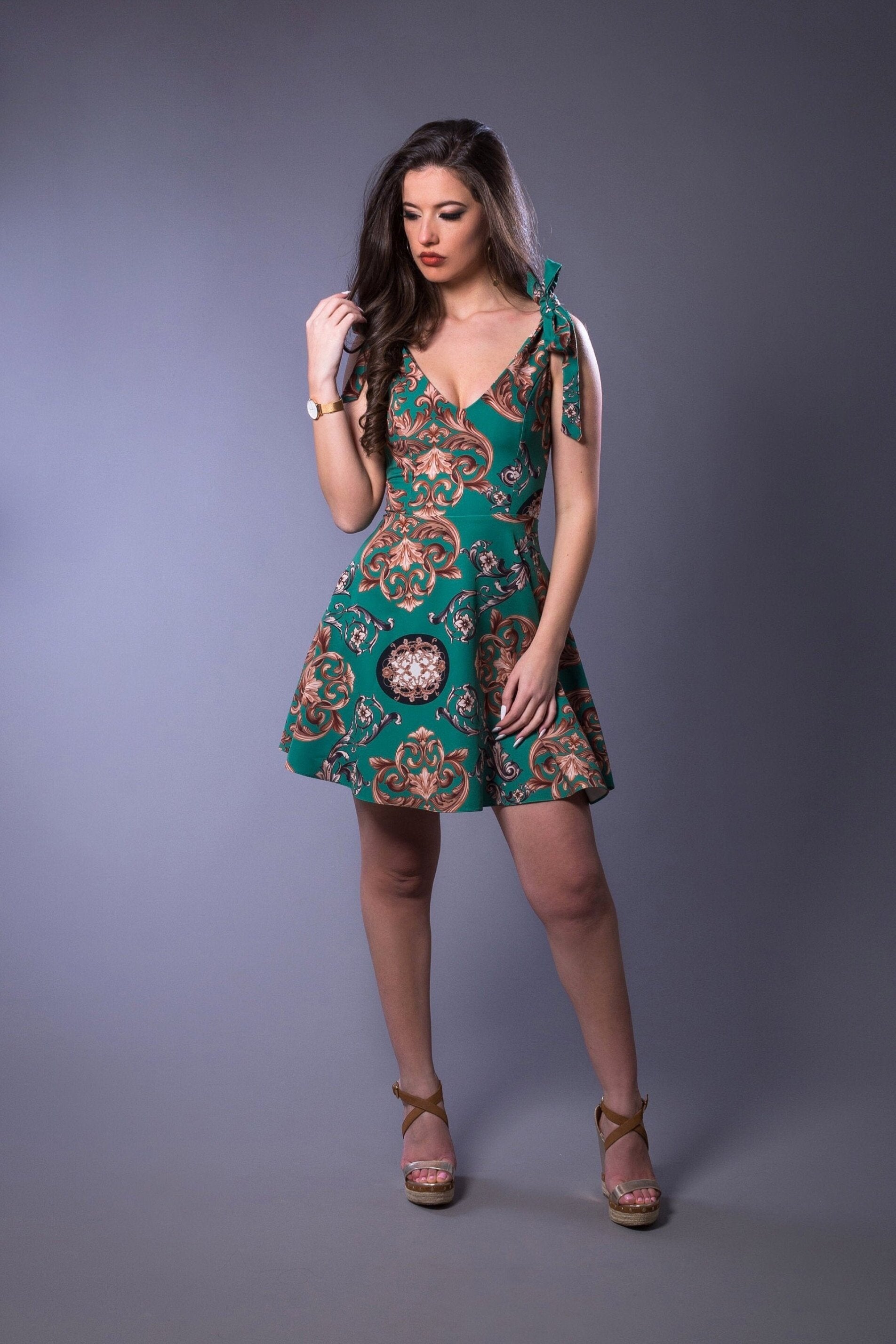 woman wearing green short circle dress with tie straps