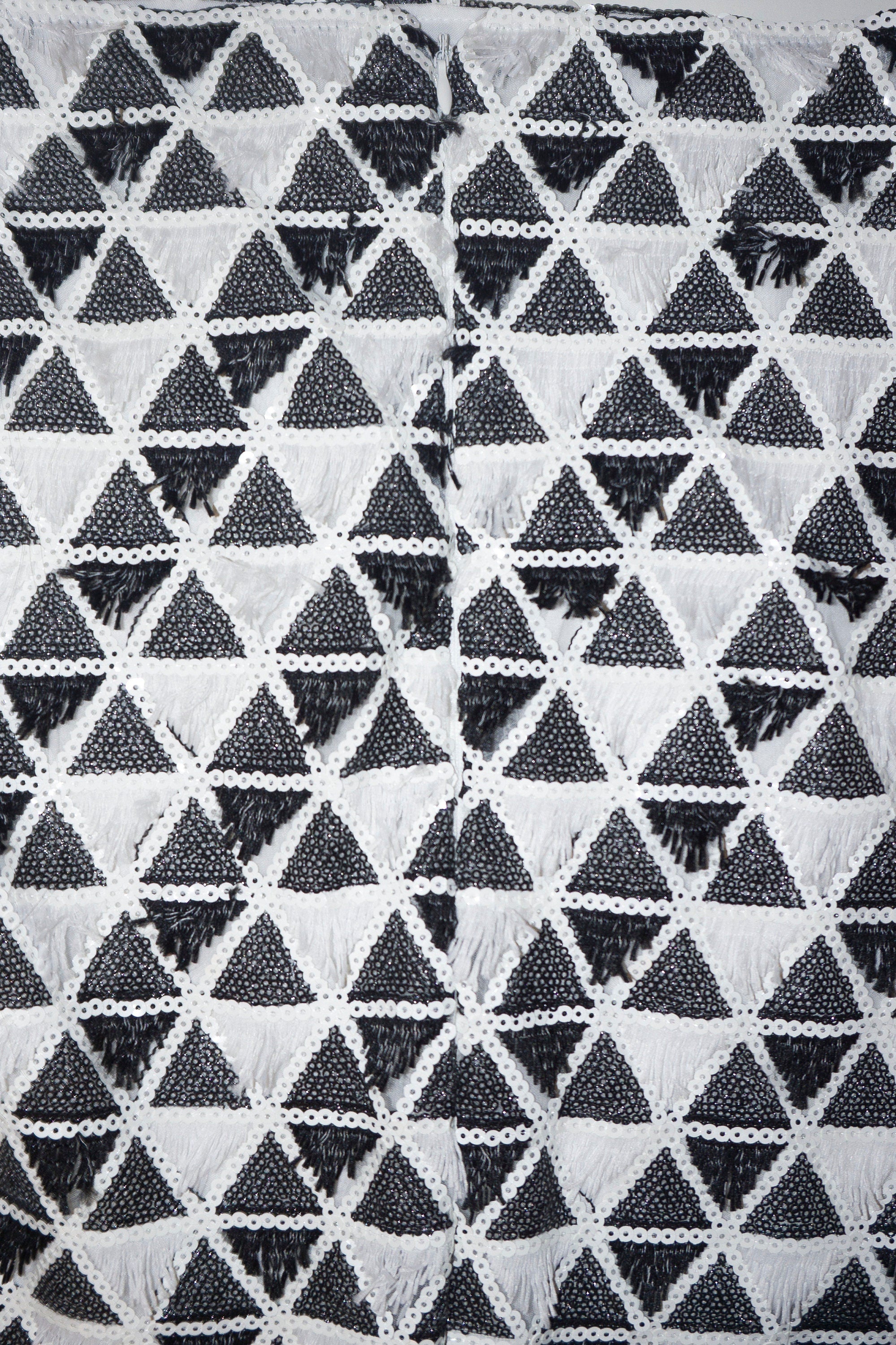 close up of skirt fabric fringe and sequins